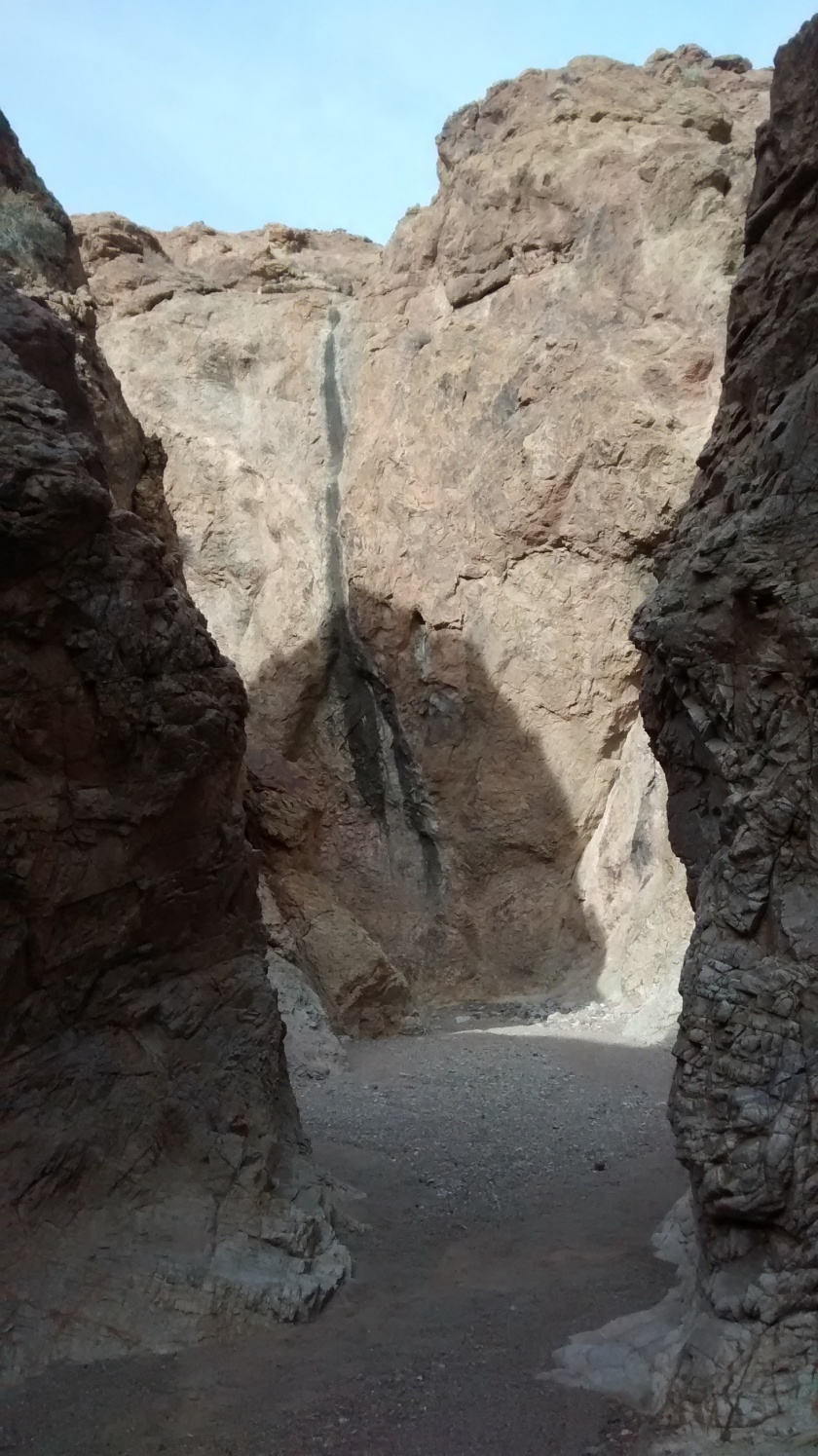 Through a small slot canyon.